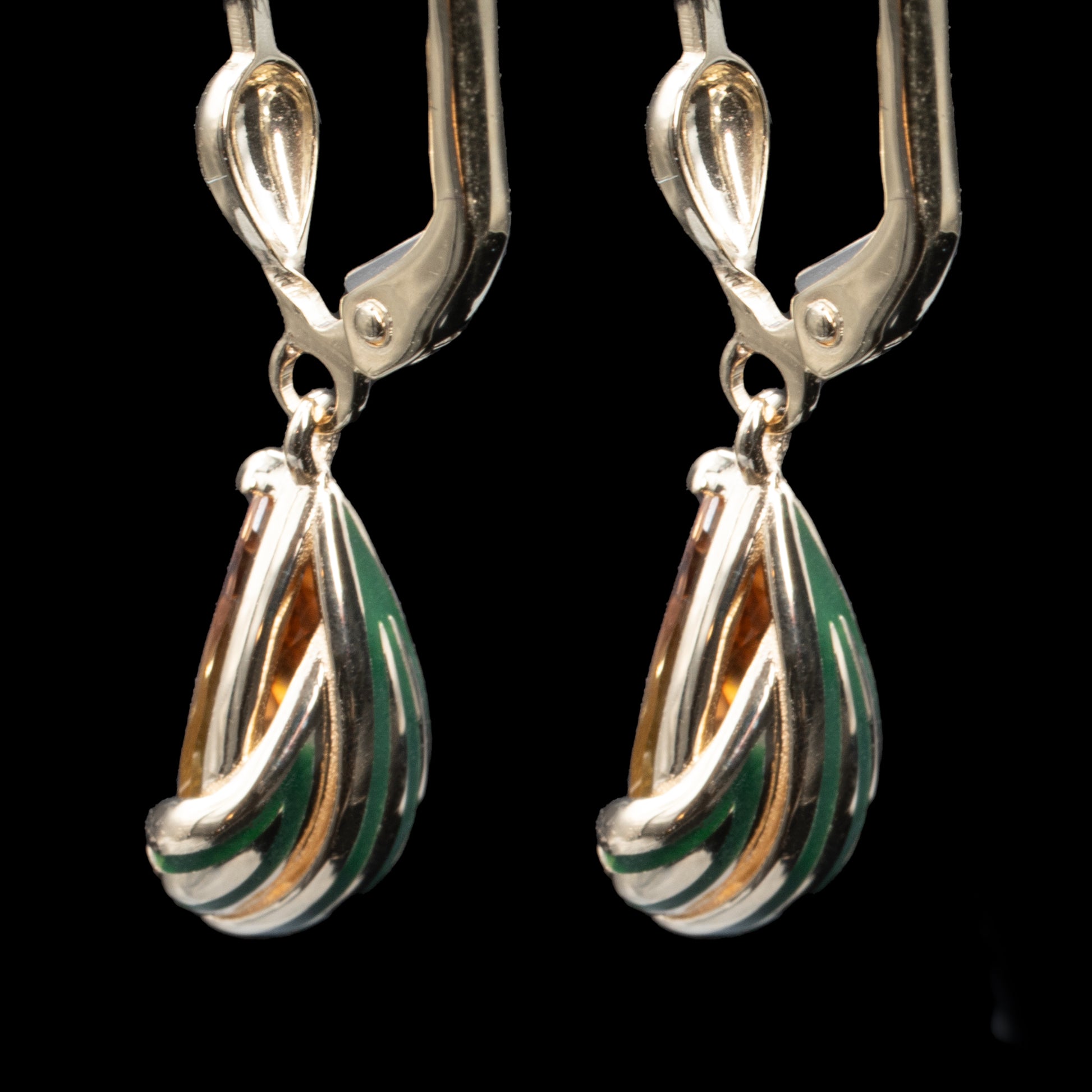 back side of gold earrings with green enamel