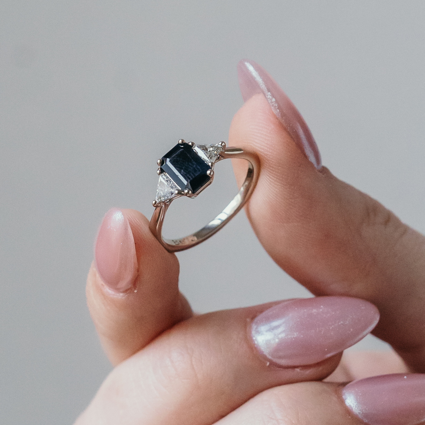 black sapphire emerald cut engagement ring with diamonds gold