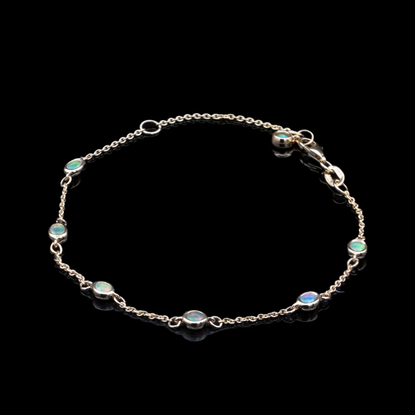 opal bezel set charm bracelet in yellow gold