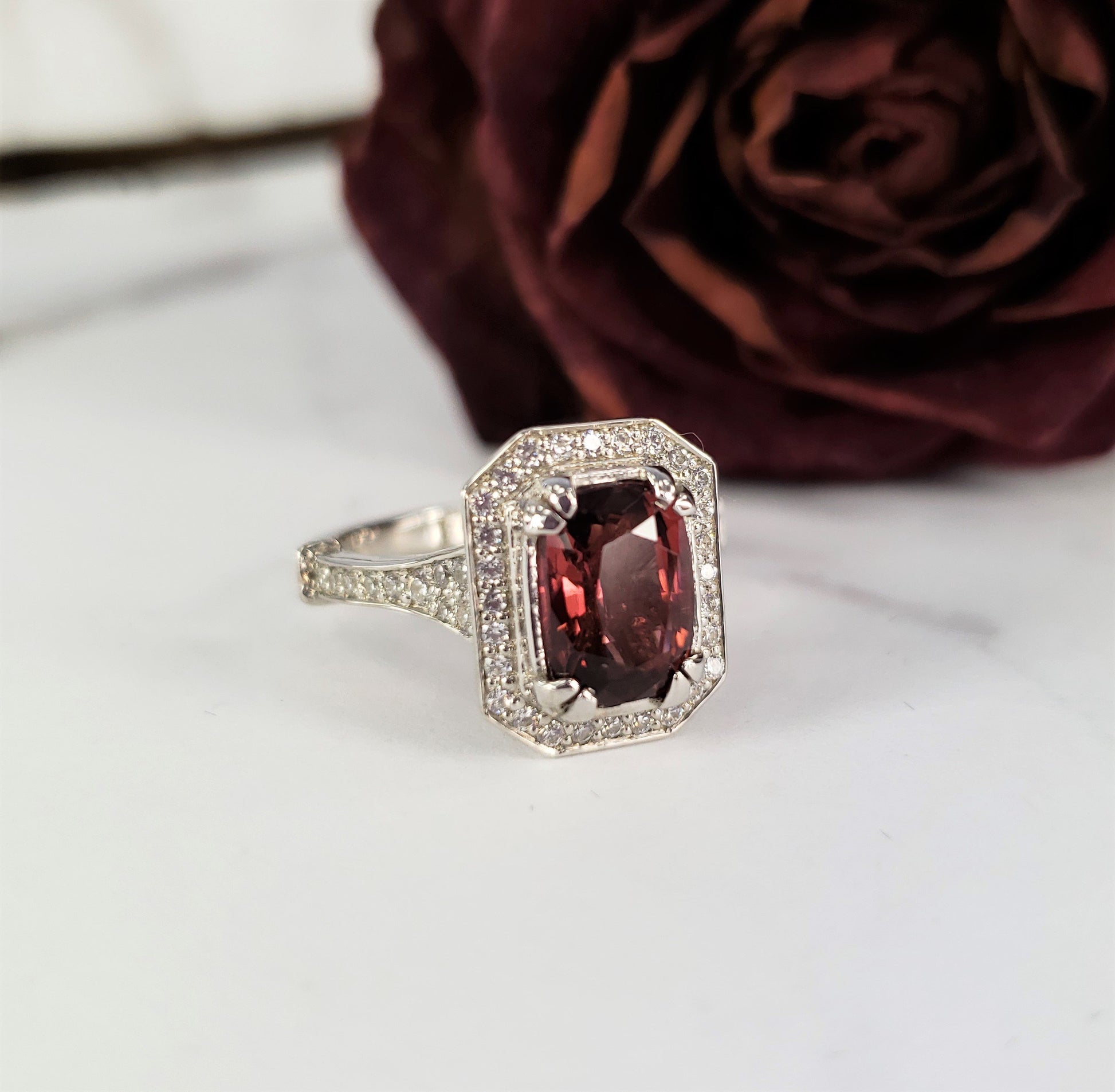 art deco engagement ring with diamond halo and tourmaline