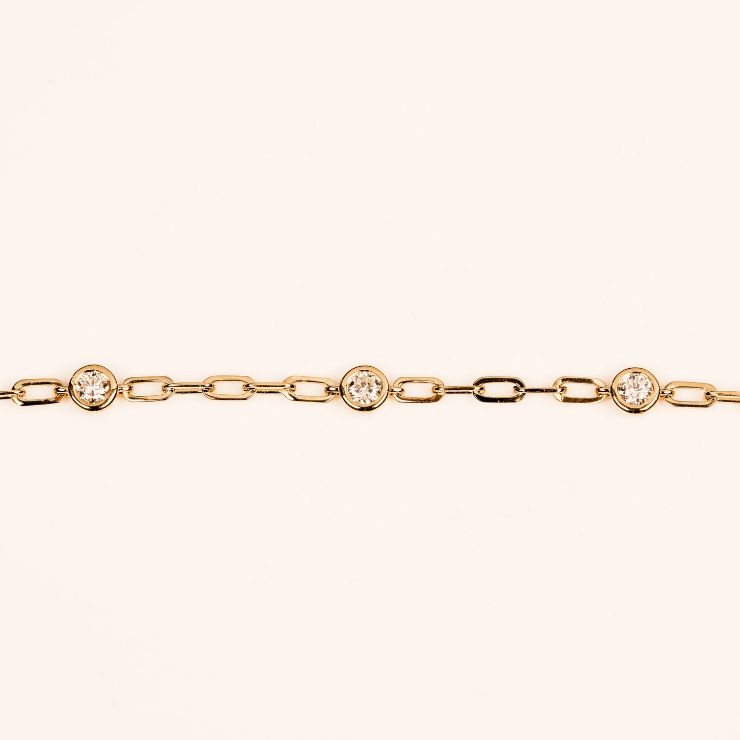 diamond charm necklace in 14k yellow on a paperclip necklace chain.