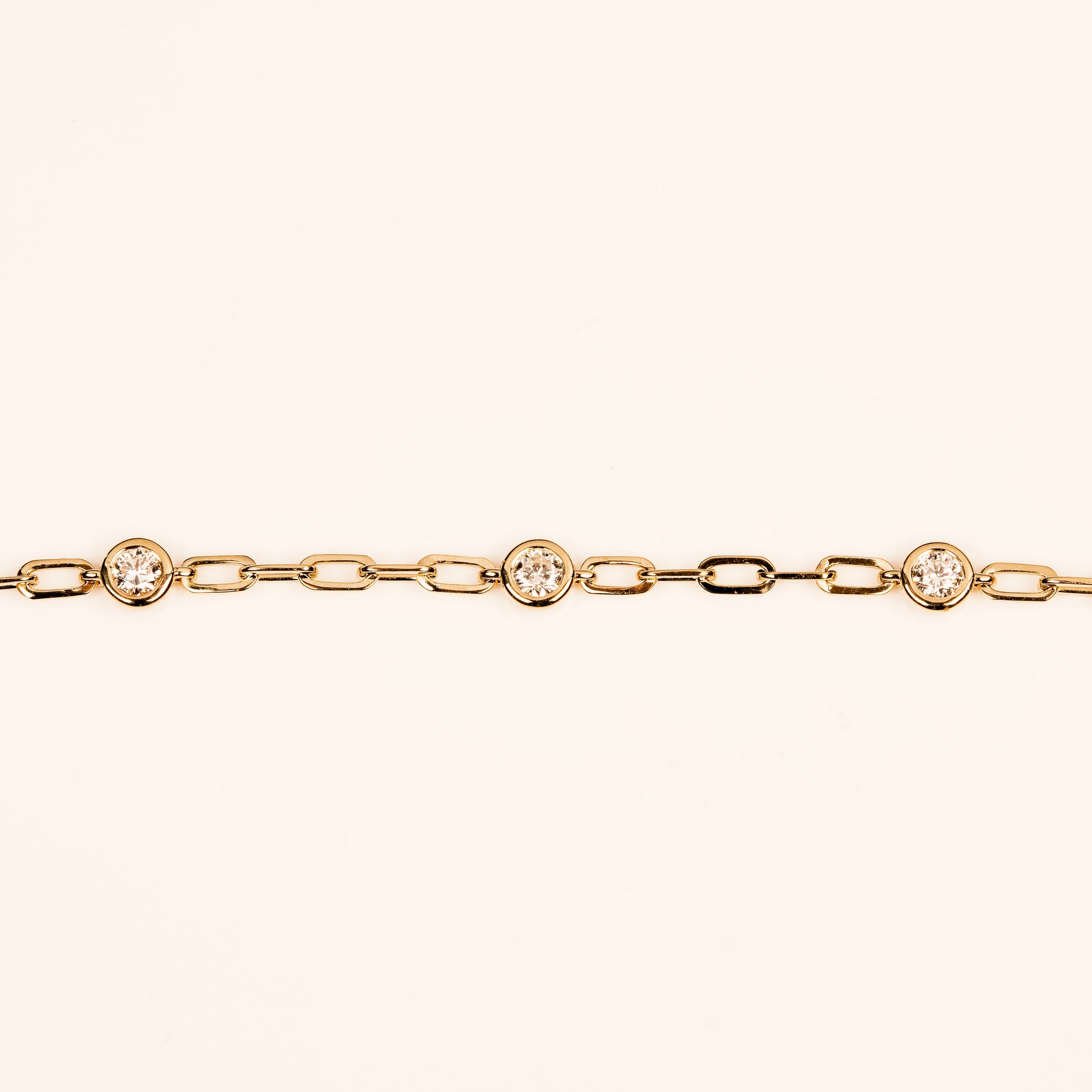 diamond charm necklace in 14k yellow on a paperclip necklace chain.