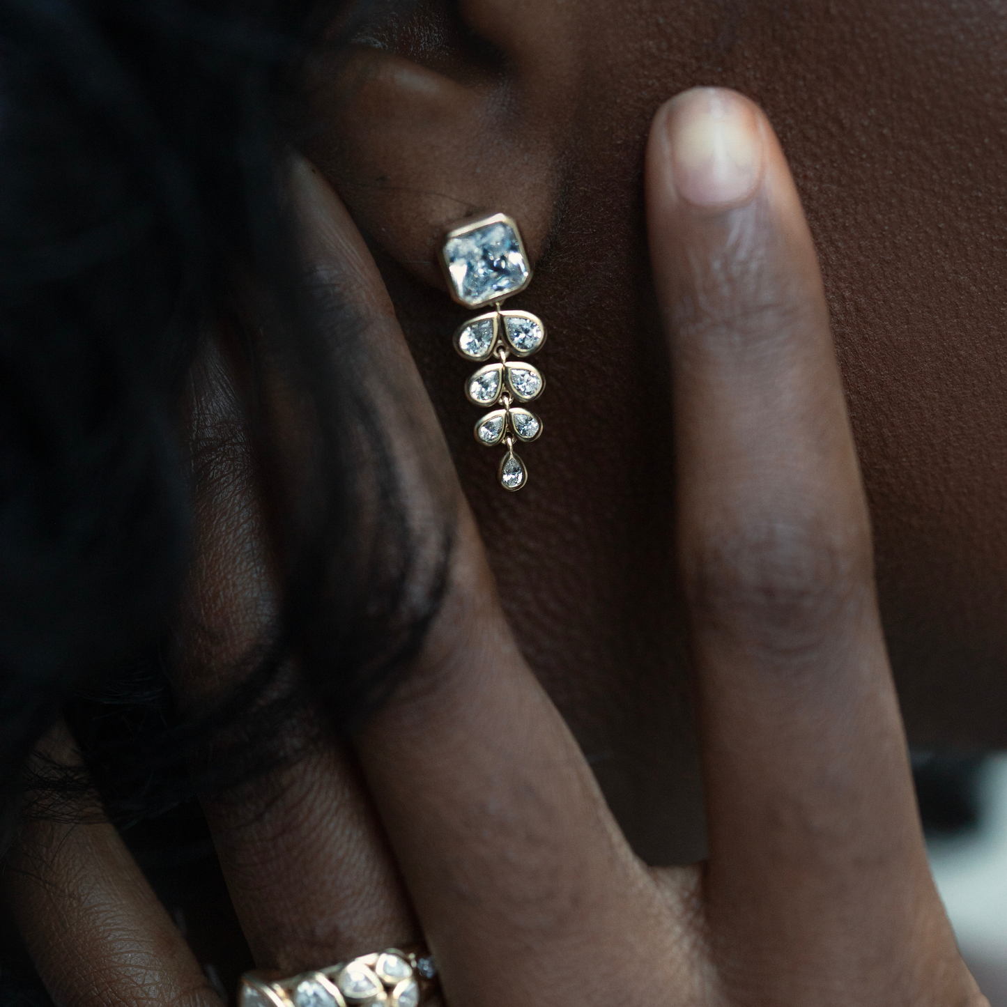 Diamond earring and engagement ring set in yellow gold.