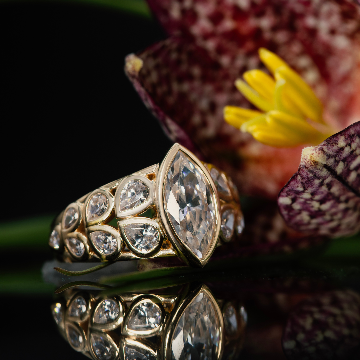 Diamond marquise engagement ring set in 14K yellow gold, bezels.