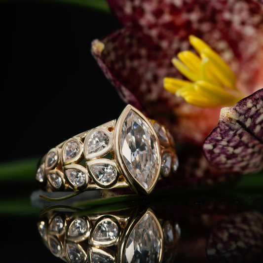 Diamond marquise engagement ring set in 14K yellow gold, bezels.
