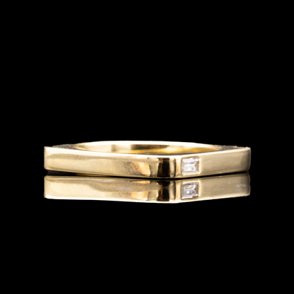 yellow gold unisex wedding ring with diamond baguette