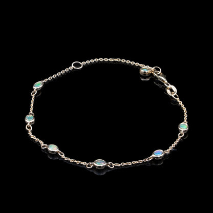opal bezel set charm bracelet in yellow gold