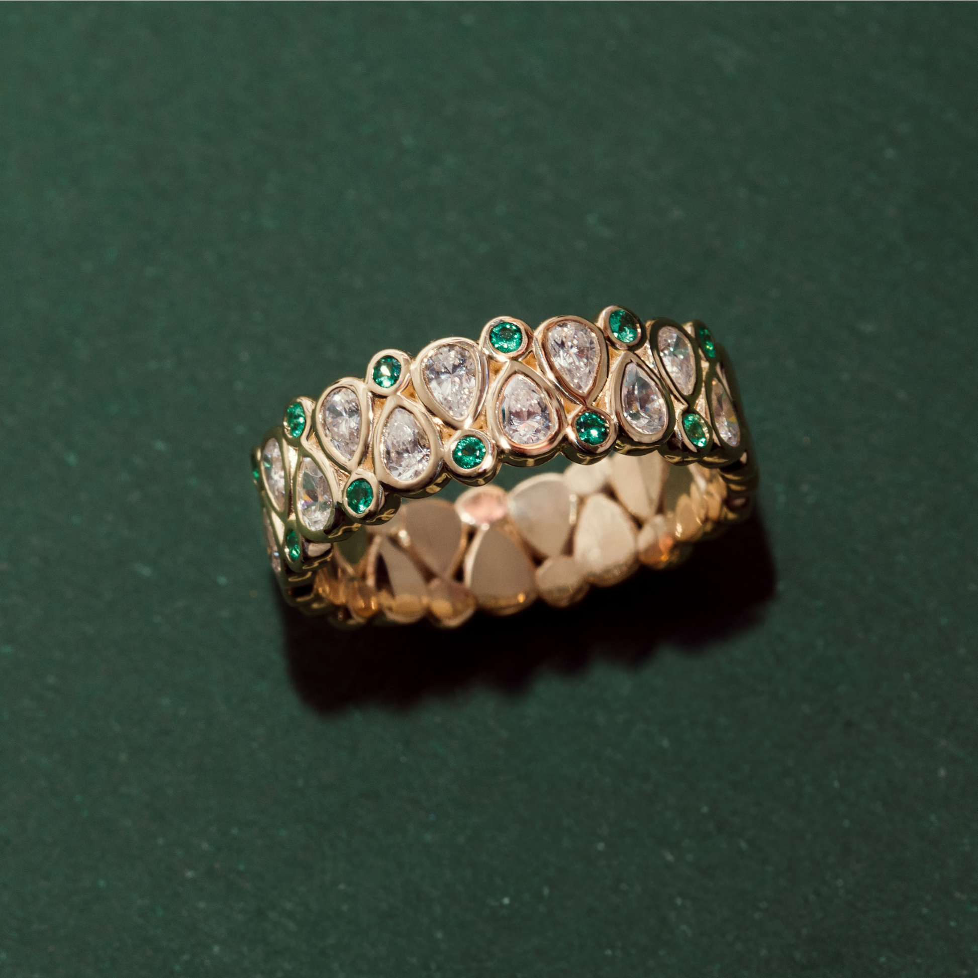 yellow gold and emerald wedding band with unique diamond pattern