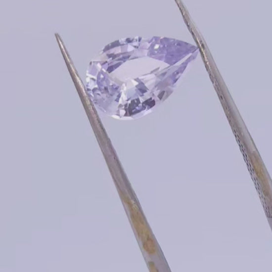 No heat silver sapphire, pear cut with purple undertone.