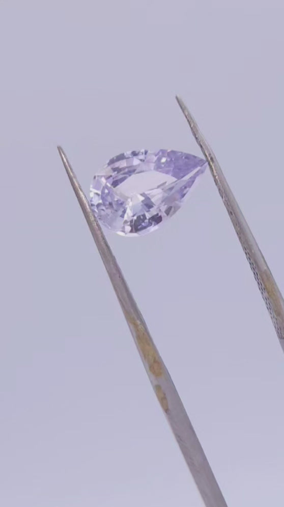 No heat silver sapphire, pear cut with purple undertone.