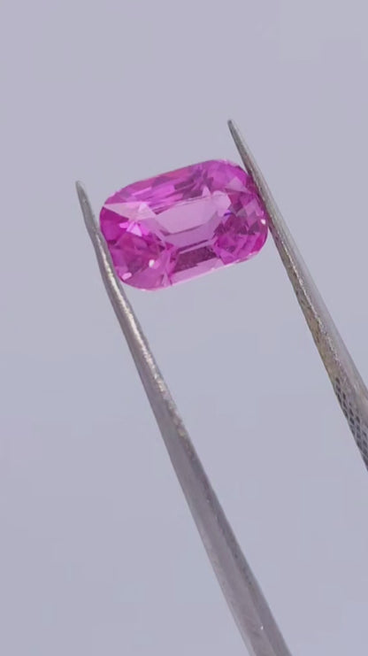 Hot pink sapphire with intense saturation, elongated cushion cut, natural gemstone for sale
