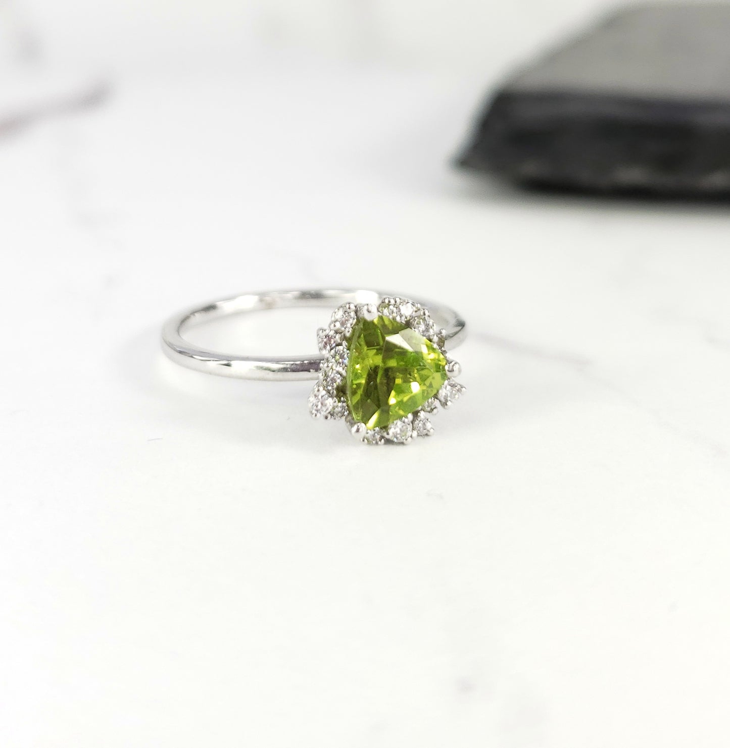 Trillion cut peridot ring with diamonds in white gold