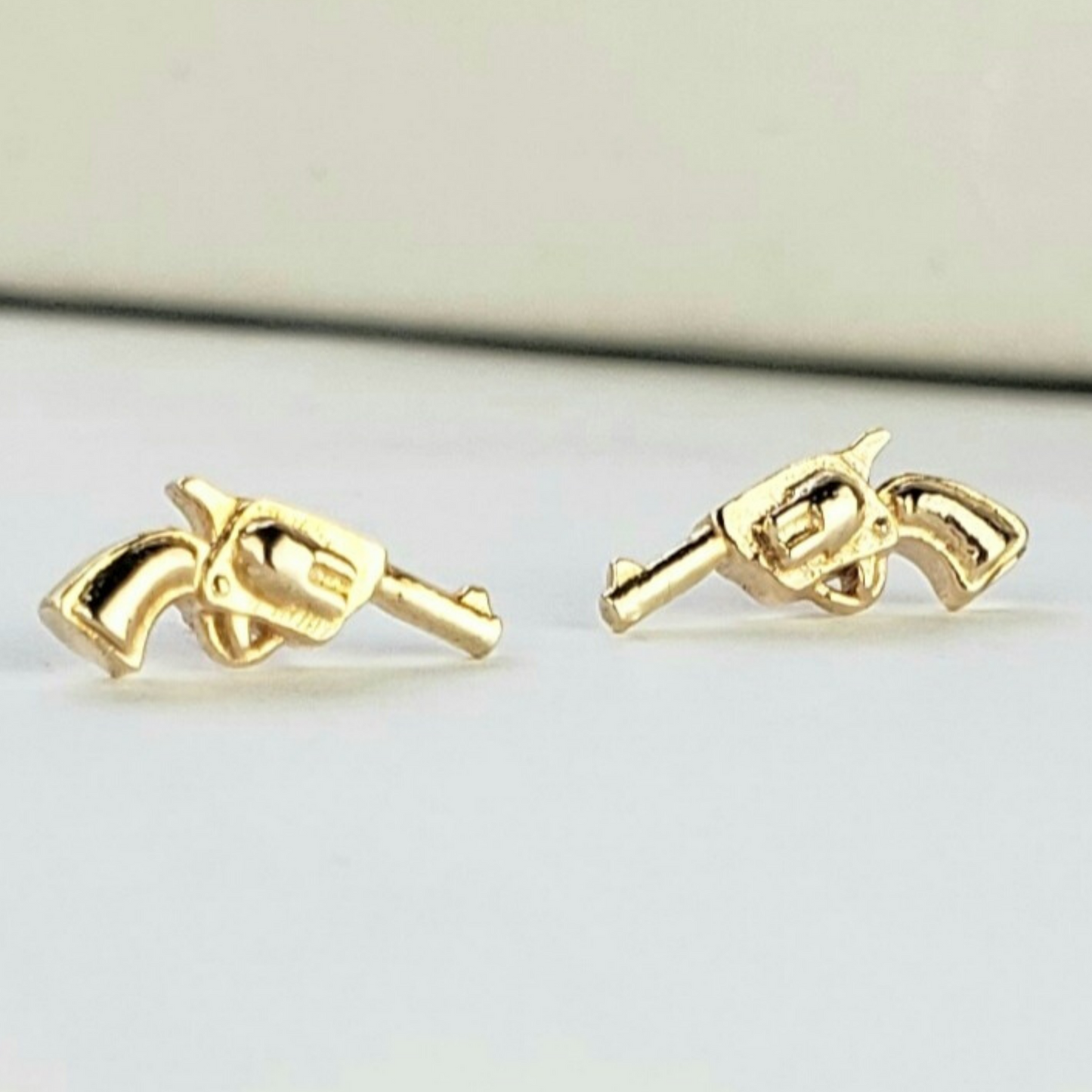 gold gun earrings